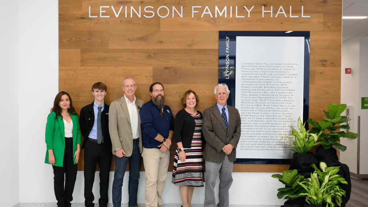 Image from Group of Students, Faculty, and Frank Levinson in front of Levinson Family Hall Plaque article